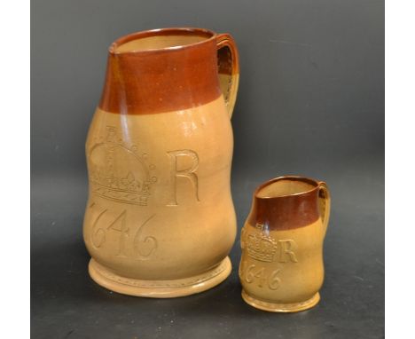 A large Doulton Lambeth salt glazed stoneware two quart jack, in brown and buff, stitched leather effect detailing, incised w