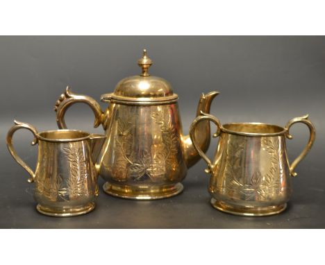 An Early 20th century white metal three piece tea service, tapering conical body, engraved floral wreath, stamped W to bases,