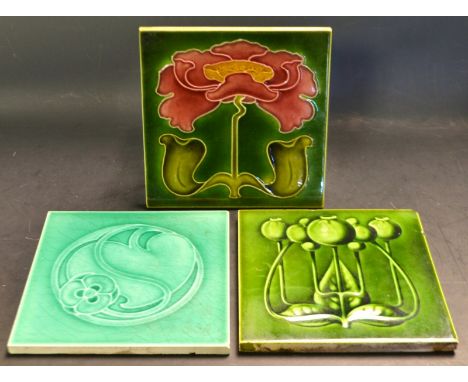 Tiles - an early 20th  century Art Nouveau dust pressed tile,  tube lined with foliate roundel, on a green ground,  15cm squa