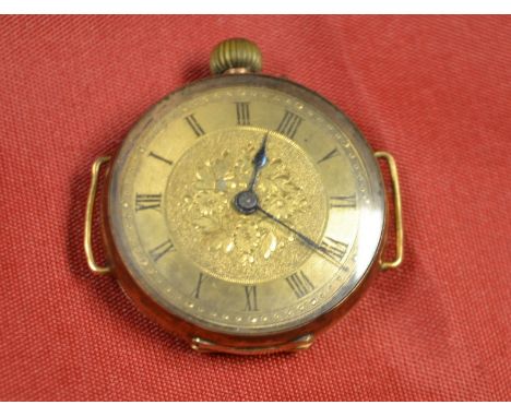 A 14ct gold case wrist watch head, yellow metal floral dial, Roman numerals, manual wind movement, 28mm diam, 17.4g gross