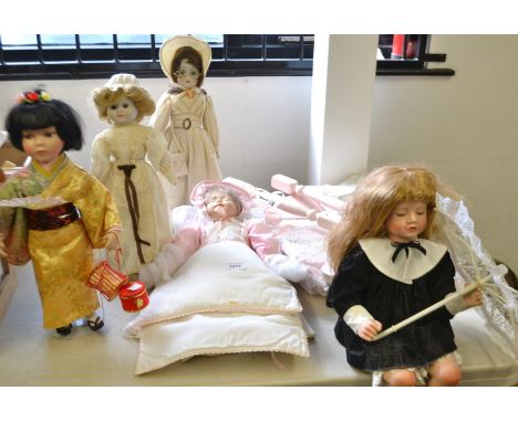 Dolls - a modern ceramic naturalistically modelled baby doll; others; a doll's cradle (6)