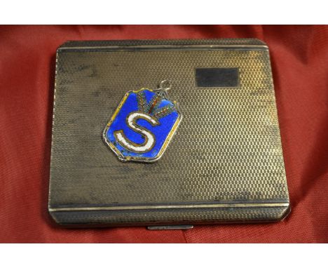 A silver engine turned cigarette case, Birmingham 1940; a silver  medal, Finnish Shooting School 1930, enammelled (2)