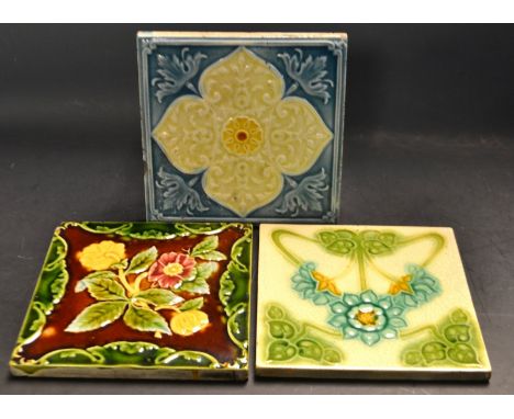 Tiles - an early 20th  century Art Nouveau dust pressed tile,  tube lined with  sinuous flowerhead and foliage, 15cm square; 