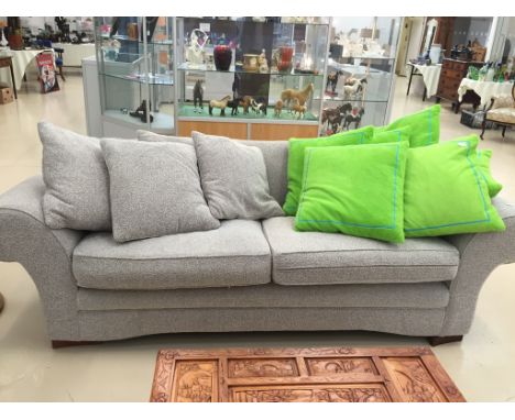 A modern beige/grey mix fabric sofa and a single arm chair with cushions