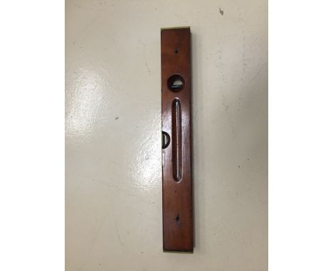 A vintage mahogany spirit level