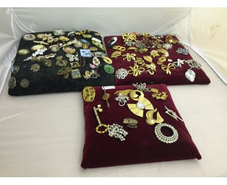 Three cushions of vintage brooches