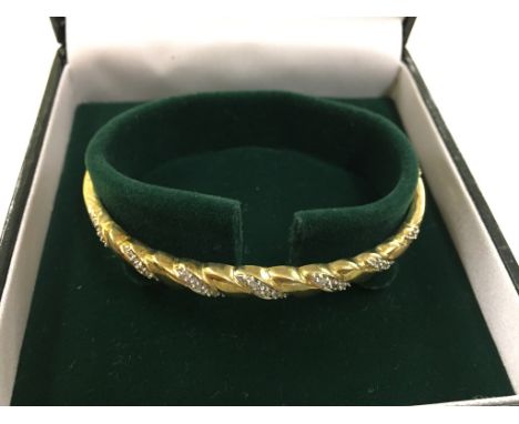 A 9ct diamond set bangle 0.15ct