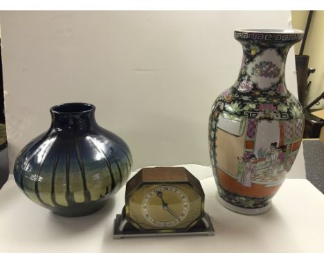 A 1920s Elliott clock; together with a famille noir vase and a studio vase