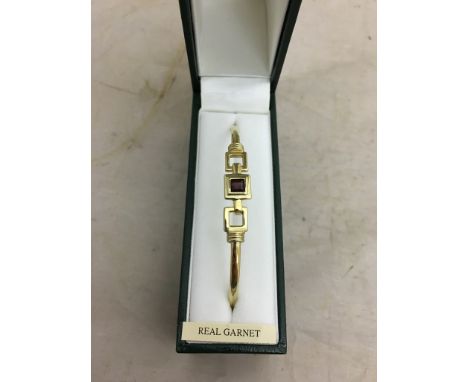 A 9ct garnet bangle