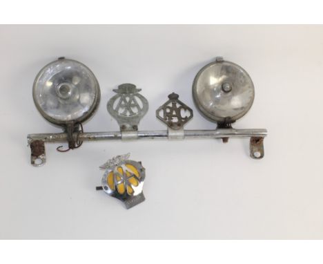Two vintage Lucas car headlights, together with an AA winged car badge (6C73039), an RAC diamond shaped badge, an Automobile 