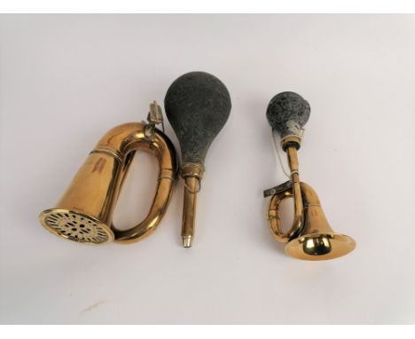 Two vintage brass car horns, both with intact rubber bulbs, one stamped 'India', the largest measuring 45cm long 
