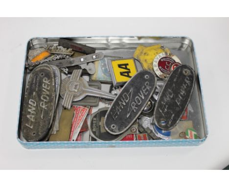 A collection of plastic and metal vintage car badges and plaques, to include a 9C72005 AA car badge, a plastic RAC badge, hal