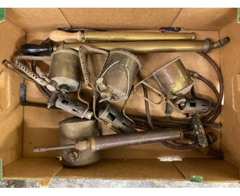 A box of brass tools including blow lamps.