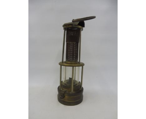 A brass miner's lamp.