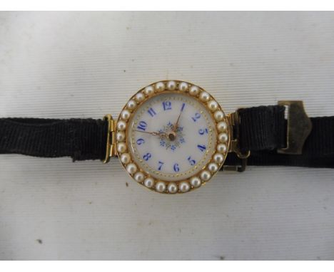 A high quality yellow metal, probably at least 15ct gold ladies wristwatch, the circular white enamel dial with blue numerals