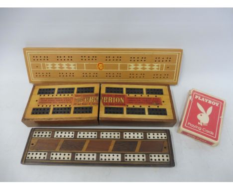 A folding cribbage board containing a pack of playing cards plus two further cribbage boards.
