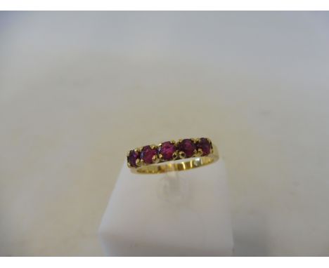 A cased French gold and ruby set ring, size L/M, 3.4g.