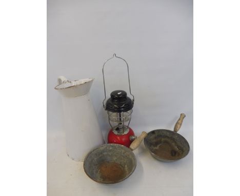 A large white enamel jug plus two pans and a 1960s tilley lamp.