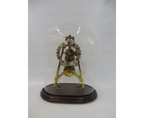 A good quality brass skeleton clock with single fusee movement, set under a glass dome, 14 1/2" h.