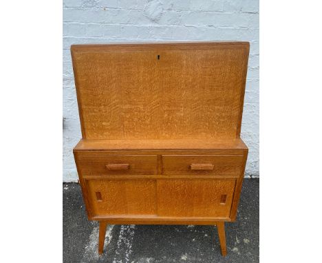 A light oak bureau, circa 1960s in the manner of Heals, 30" w x 45 1/2" h x 16" d.