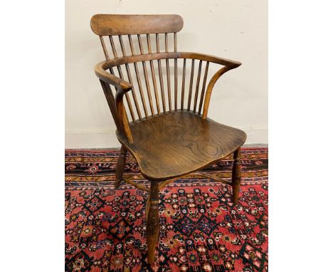 An early 19th Century yew wood low comb back Windsor armchair, 32 1/4" h.