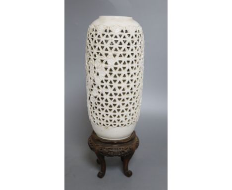 A Chinese pierced blanc de chine lantern, hardwood stand, overall height 36.5cm