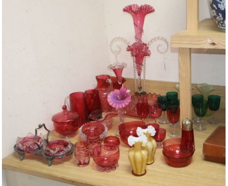 A Victorian cranberry glass epergne, height 56cm, a set of green glasses, two vaseline vases, etc
