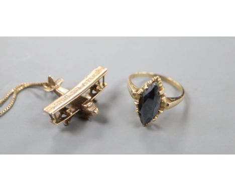 A modern 10kt and hematite navette shaped ring, size O, gross 3.2 grams and a 9ct gold bi-plane pendant on a 10kt chain, gros