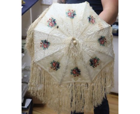 A Victorian embossed velvet and cream silk ladies parasol, with coloured floral cartouches, silk fringing and an ivory handle