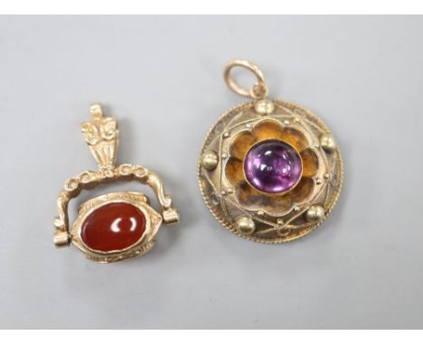 A Victorian yellow metal and cabochon amethyst set pendant, 20mm and a modern 9ct gold and gem set fob, gross 8.6 grams.