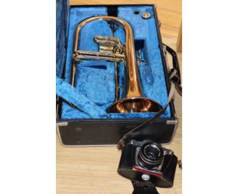 A Yamaha trumpet and a cased camera
