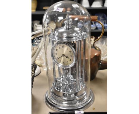 A Schatz chromed metal perpetual motion mantel clock, the silvered dial having arabic numerals, the backplate stamped with th