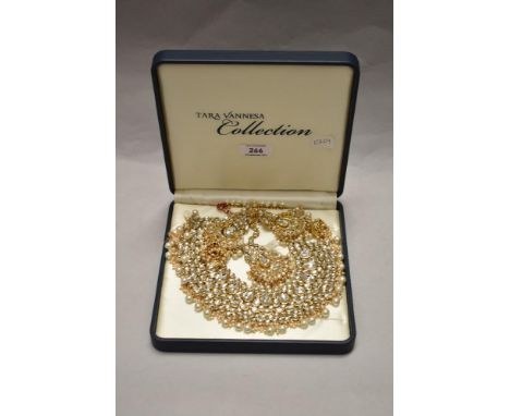 A vintage Tara Vanessa Collection jewellery box set comprising earrings, necklace, and bracelet of matching gold coloured and