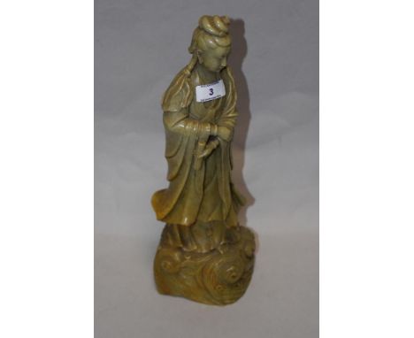 A 20th century Chinese carved green stone (possibly a varigated jade) figure of Qui Yen.