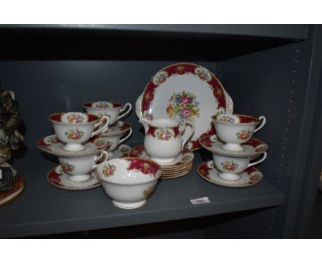 A collection of Shelley tableware, including cups and saucers, cream jug, sugar basin and cake plate, having red and white gr
