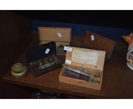 A variety of vintage and antique weights and two sets of scales.