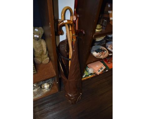 A group of mixed walking sticks, golfing umbrella, flask stick (with internal glass flask' etc