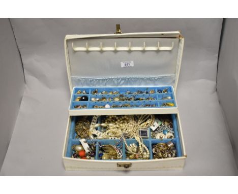 A mid-20th Century jewellery box containing miscellaneous decorative jewellery, including synthetic pearl necklaces, rings, a