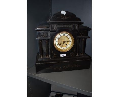 A Victorian black marble mantel clock of architectural structure, with etched detailing and bevelled glass door with enamel f