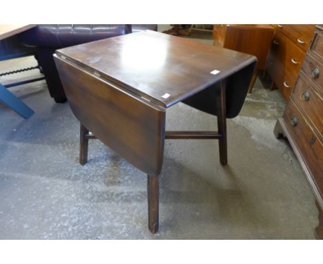 An Ercol Golden Dawn elm and beech Windsor drop leaf table 