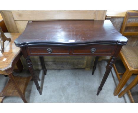 A mahogany serpentine fold over card table 