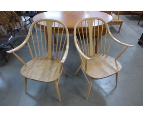 A pair of Ercol Blonde elm and beech 514 model Windsor cowhorn armchairs 