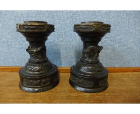 A pair of 19th Century Chinese bronze stands, 15cms h 