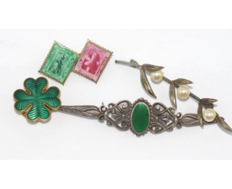 Three vintage brooches including one with Egyptian 'stamps' together with a guilloche enamel button cover