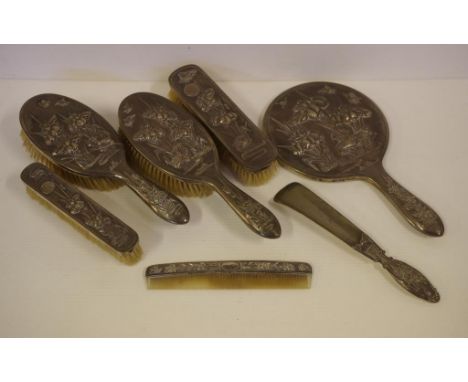 Chinese silver dressing table set comprising of a hand mirror (26.5cm long), 4 various brushes, a shoehorn and comb, all (exc