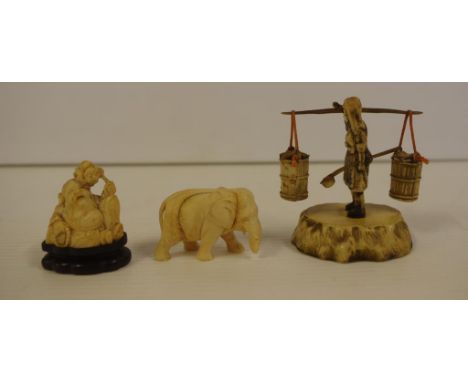 Two Chinese carved ivory figurines circa 1930 comprising of a Buddha on wooden stand 4.5cm high and an elephant (trunk damage