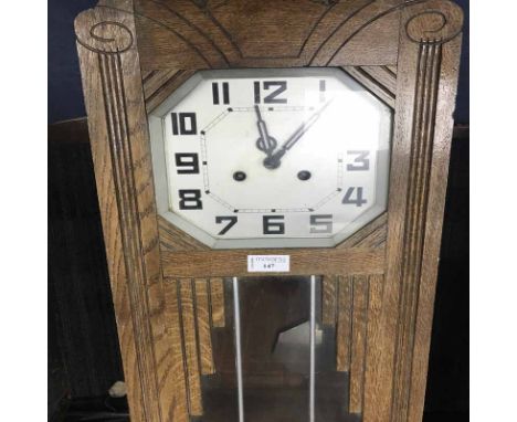 WALL CLOCK OF ART DECO DESIGN WITH SILVERISED DIALin an oak case