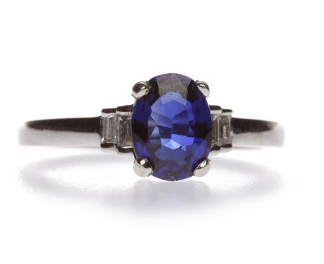 SAPPHIRE AND DIAMOND RINGthe central oval sapphire of approximately 0.85 carats flanked by two baguette cut diamonds to each 