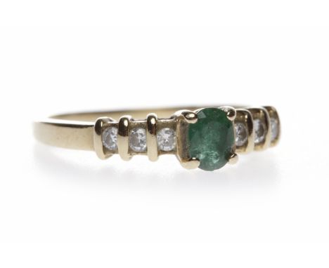 EMERALD AND DIAMOND RINGthe central oval emerald 4.8mm long and on round brilliant cut diamond set shoulders, in fourteen car