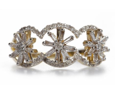 IMPRESSIVE DIAMOND DRESS RINGwith three spinning star shaped sections, each set with round and baguette cut stones, within a 